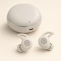 Alpine White Tuck Buds wireless earbuds beside their charging case